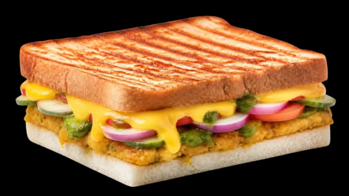Grilled veg cheese sandwich with melting cheese, vegetables and green chutney